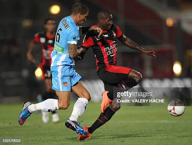 Nice's forward Franck Dja Djedje vies with Ajaccio's defender Carl Medjani during their French L1 football match OGC Nice vs AC Ajaccio, on August...