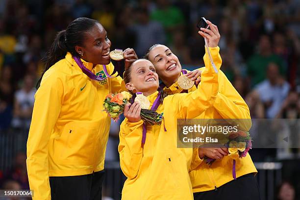 Fabiana Claudino, Fabiana Oliveira and Sheilla Castro of Brazil pose for a photo with their medals after defeating the United States to win the...