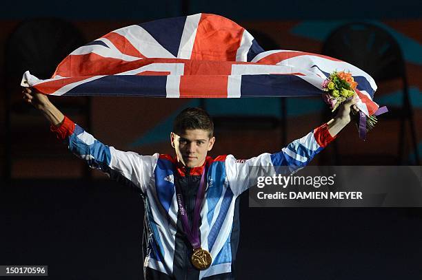 Gold medalist Luke Campbell of Great Britain celebrates with the British national flag during the awards ceremony for the Bantamweight boxing...