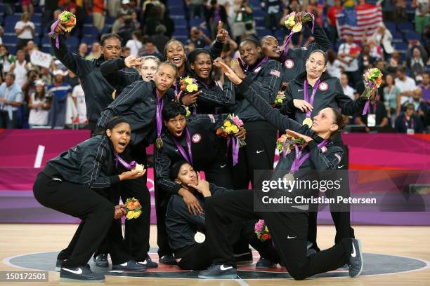 The United States players pose for a photo with their gold medals during the medal ceremony for the Women's Basketball on Day 15 of the London 2012...