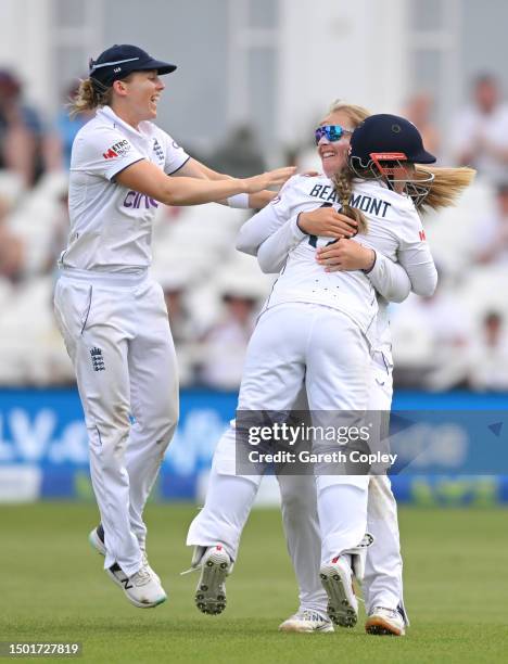 Sophie Ecclestone of England celebrates with Heather Knight and Tammy Beaumont after bowling Beth Mooney of Australia during day four of the LV=...