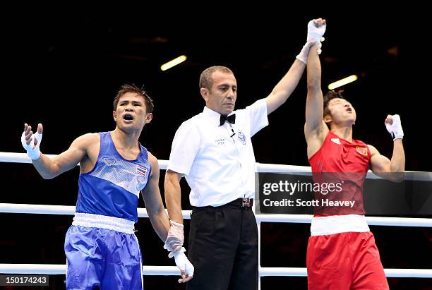 Shiming Zou of China celebrates his victory as Kaeo Pongprayoon of Thailand reacts after the Men's Light Fly Boxing final bout on Day 15 of the...