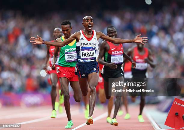 Mohamed Farah of Great Britain celebrates as he crosses the finish line to win gold ahead of Dejen Gebremeskel of Ethiopia and Thomas Pkemei...