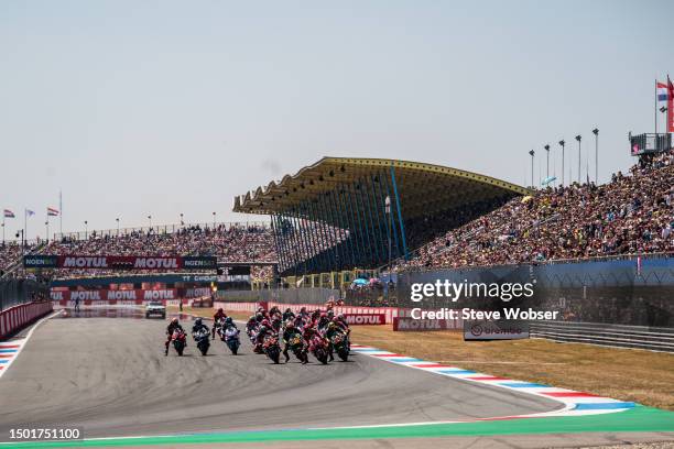 MotoGP riders on their way to turn one after the start during the Race of the MotoGP Motul TT Assen at TT Circuit Assen on June 25, 2023 in Assen,...