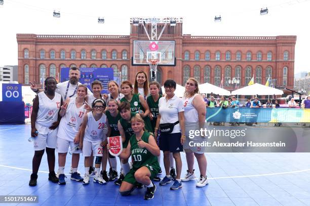 The teams of Lithuania and Italy pose together after the Women's Team Competition 3x3 Basketball Gold Medal match at Neptunbrunnen in front of the...