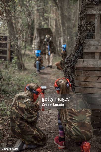 young children playing paintball together during a skirmish - paintball stock pictures, royalty-free photos & images