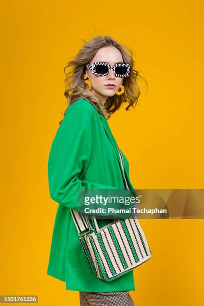 fashionable woman wearing green blazer - fashionable girl stock pictures, royalty-free photos & images