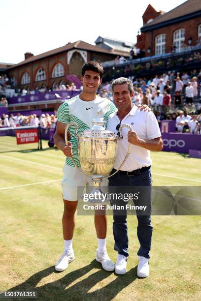 Carlos Alcaraz of Spain poses with the winner's trophy alongside father, Carlos Snr. After victory against Alex De Minaur of Australia in the Men's...