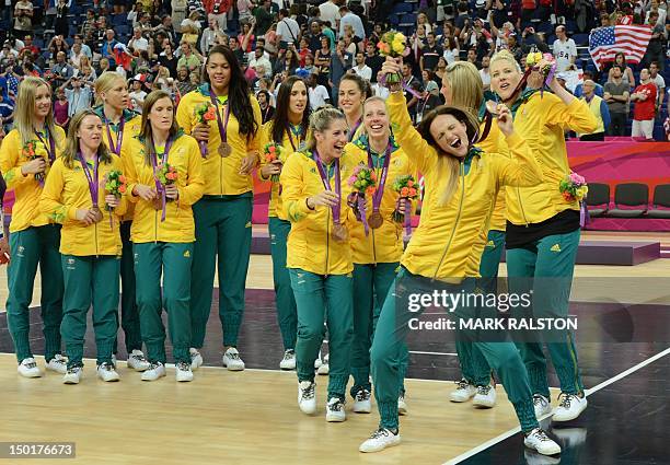 Australia's players pose after winning the bronze medal in the London 2012 Olympic Games women's basketball competition at the North Greenwich Arena...