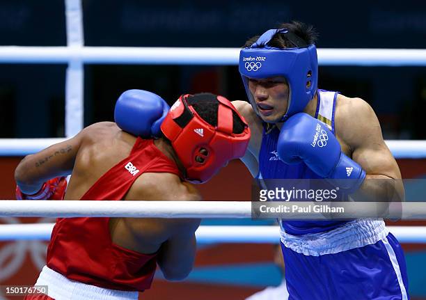Ryota Murata of Japan exchanges punches with Esquiva Falcao Florentino of Brazil during the Men's Middle Boxing final bout on Day 15 of the London...