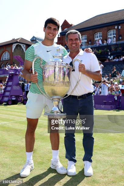 Carlos Alcaraz of Spain poses with the winner's trophy alongside father, Carlos Snr. After victory against Alex De Minaur of Australia in the Men's...