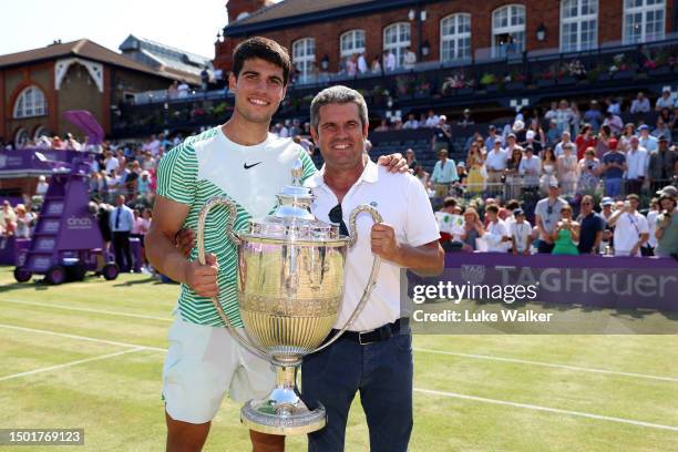 Carlos Alcaraz of Spain poses with the winner's trophy alongside father, Carlos Snr. After victory against Alex De Minaur of Australia in the Men's...