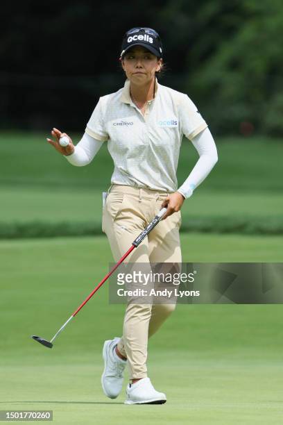 Jenny Shin of South Korea acknowledges fans after a putt on the first green during the final round of the KPMG Women's PGA Championship at Baltusrol...