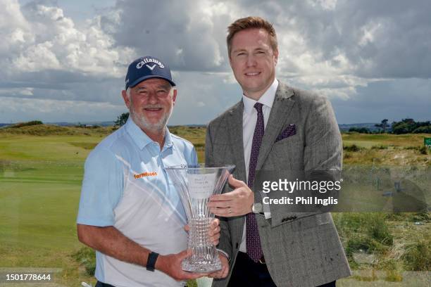 Peter Baker of England and David Adams, Head of Tour at Legends Tour pose with the trophy during Day Three of the Irish Legends 2023 at Seapoint Golf...
