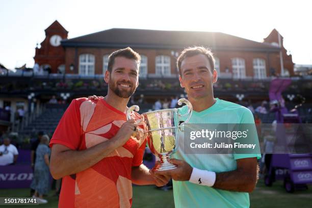 Austin Krajicek of United States and Ivan Dodig of Croatia celebrate with the winner's trophy after victory against Taylor Fritz of United States and...