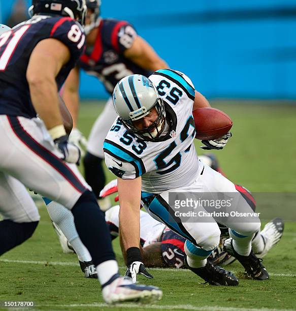 Carolina Panthers linebacker Jason Phillips intercepts a pass by Houston Texans quarterback Matt Schaub during first-quarter action at Bank of...