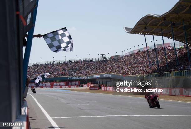 Francesco Bagnaia of Italy and Ducati Lenovo Team cuts the finish lane and celebrates the victory at the end of the MotoGP race during the MotoGP of...