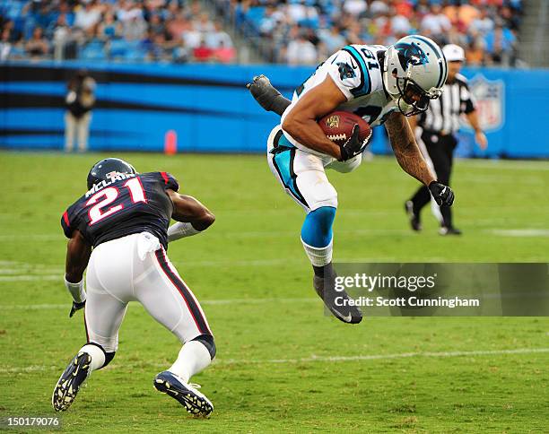 Kealoha Pilares of the Carolina Panthers runs with a catch against Brice McClain of the Houston Texans at Bank of America Stadium on August 11, 2012...