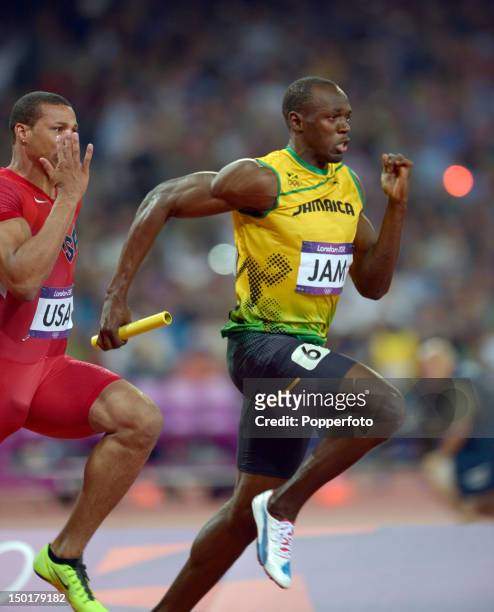 Usain Bolt of Jamaica ahead of Ryan Bailey of the United States to win gold and set a new world record of 36.84 during the Men's 4 x 100m Relay Final...