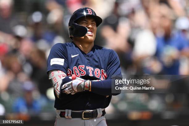 Masataka Yoshida of the Boston Red Sox grimaces after being hit by a pitch in the second inning from Tanner Banks of the Chicago White Sox at...
