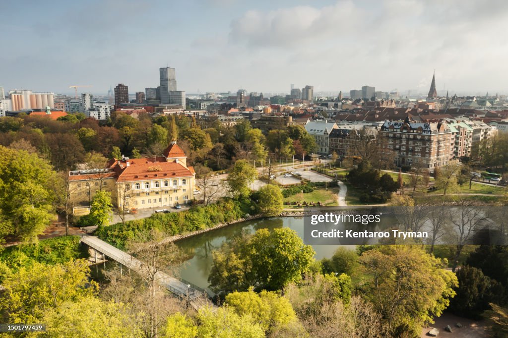 Aerial view of a large green park in the middle of a big city.