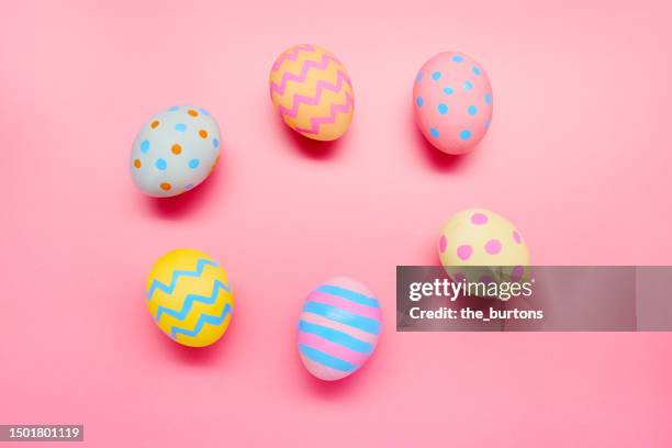 colorful painted easter eggs on pink background - happy easter stock pictures, royalty-free photos & images