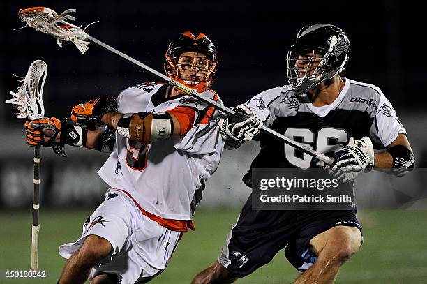 Casey Cittadino of the Denver Outlaws dodges Mike Simon of the Chesapeake Bayhawks in the second half at Navy-Marines Memorial Stadium on August 11,...