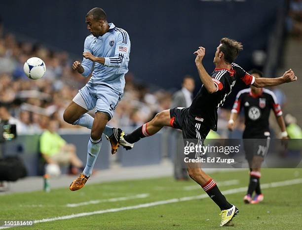 Teal Bunbury of the Sporting Kansas City tries to gain control over of the ball past Emiliano Dudar of the D.C. United in the second half at...