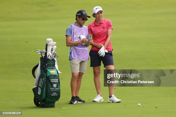 Carlota Ciganda of Spain and her caddie plan a shot from the 17th fairway during the final round of the KPMG Women's PGA Championship at Baltusrol...