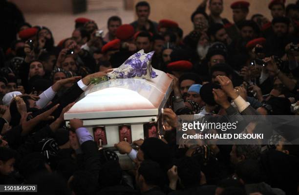 Egyptian Coptic Christians carry the coffin of Coptic Pope Shenuda III, the spiritual leader of the Middle East's largest Christian minority, during...