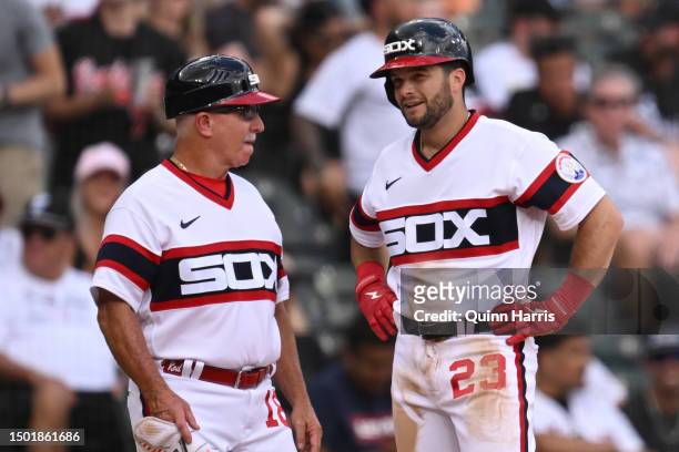 Andrew Benintendi discusses with third base coach Eddie Rodriguez of the Chicago White Sox after advancing to third base from his RBI double in the...