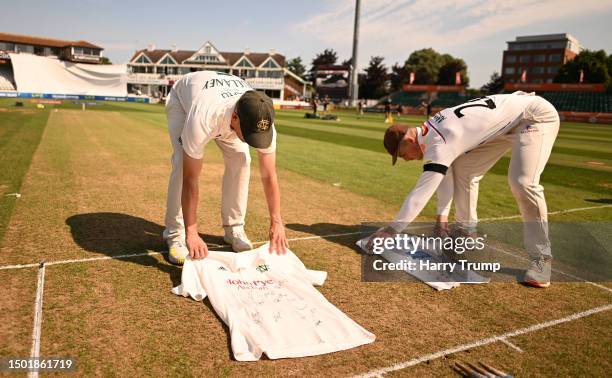 Tom Abell of Somerset and Steven Mullaney of Nottinghamshire lay signed shirts on the square displaying the name of Barnaby Webber ahead of Day One...