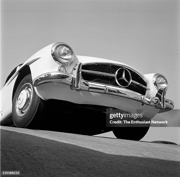 Mercedes 190SL Road Test. The front of a Mercedes-Benz 190SL crests the peak of the parking garage driveway. Looking from a worm's-eye view at the...