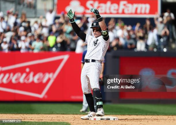 Harrison Bader of the New York Yankees celebrates after driving in two runs with a double in the eighth against the Texas Rangers inning during their...