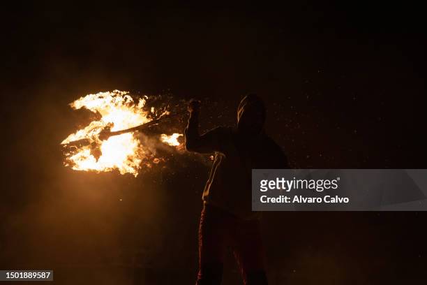 Man twirls a lit falla over his head on June 23, 2023 in Sahun, Spain. The Fallas festival in the Spanish Pyrenees is an ancient tradition that is...