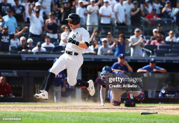 Harrison Bader of the New York Yankees scores a run off a single by Giancarlo Stanton in the eighth inning against the Texas Rangers during their...