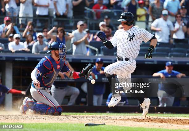 Harrison Bader of the New York Yankees scores a run off a single by Giancarlo Stanton in the eighth inning against the Texas Rangers during their...