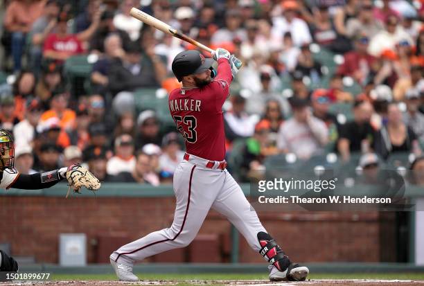 Christian Walker of the Arizona Diamondbacks hits an rbi double scoring Ketel Marte against the San Francisco Giants in the top of the first inning...