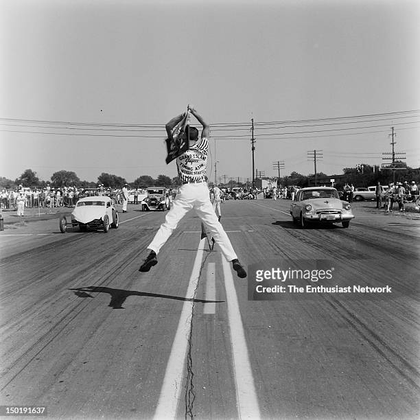 National Drag Races - Oklahoma City. Antics of enthusiastic flag men add to the excitement at the start of each race.
