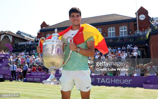 Carlos Alcaraz of Spain poses with the winner's trophy after victory against Alex De Minaur of Australia in the Men's Singles Final match on Day...