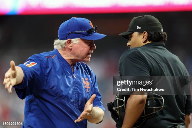 Buck Showalter of the New York Mets and umpire Erich Bacchus speak during the ninth inning of a game between the Philadelphia Phillies and the New...