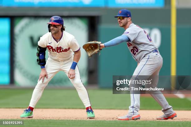 Bryce Harper of the Philadelphia Phillies and Pete Alonso of the New York Mets look on during the eighth inning at Citizens Bank Park on June 25,...