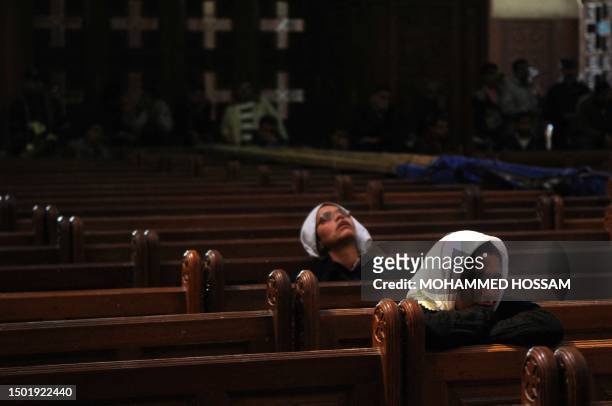 Egyptian Coptic women mourn during the funeral service of Pope Shenuda III in Saint Mark's Cathedral in Cairo on March 20, 2012 before his burial in...