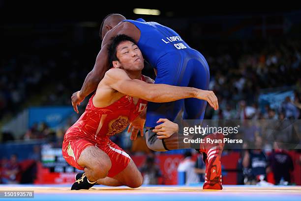 Tatsuhiro Yonemitsu of Japan in action against Livan Lopez Azcuy of Cuba in the Men's Freestyle Wrestling 66kg 1/8 final match on Day 16 of the...
