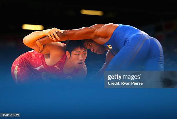 Tatsuhiro Yonemitsu of Japan in action against Livan Lopez Azcuy of Cuba in the Men's Freestyle Wrestling 66kg 1/8 final match on Day 16 of the...
