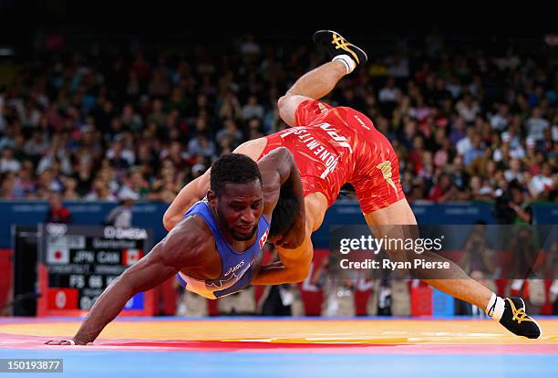 Tatsuhiro Yonemitsu of Japan in action against Haislan Veranes Garcia of Canada in the Men's Freestyle Wrestling 66kg Quarter final match on Day 16...