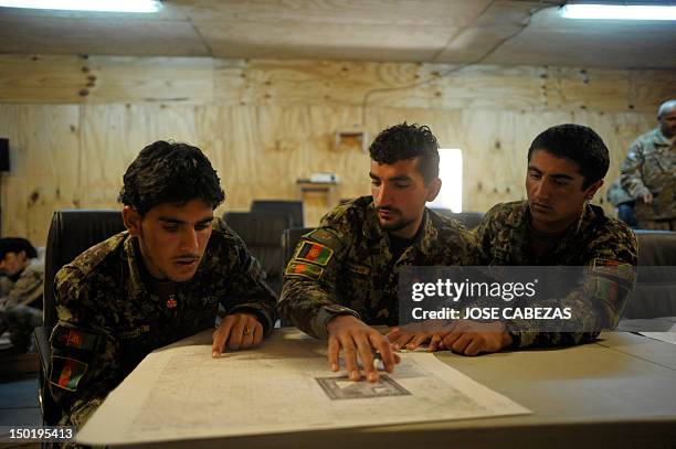 Members of the Afghan National Army participate in a map reading training session at Narizah base in Narizah, Khost Province, on August 12, 2012....
