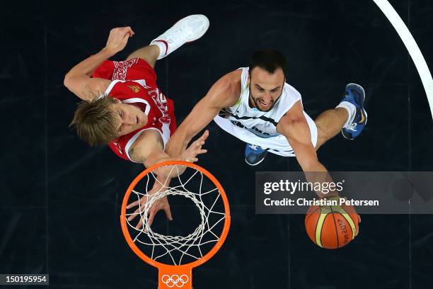 Manu Ginobili of Argentina drives to the basket against Andrey Kirilenko of Russia during the Men's Basketball bronze medal game between Russia and...