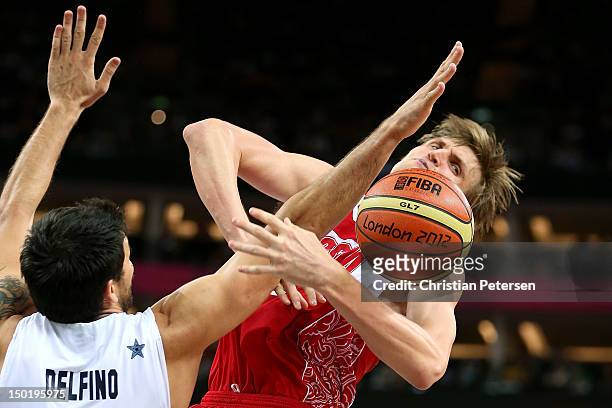 Carlos Delfino of Argentina defends Andrey Kirilenko of Russia during the Men's Basketball bronze medal game between Russia and Argentina on Day 16...