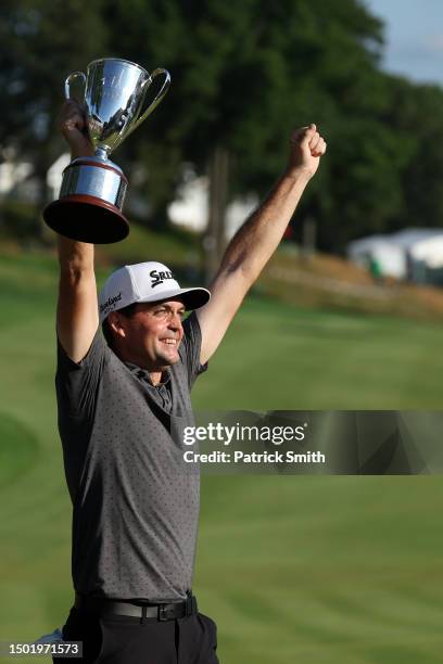 Keegan Bradley of the United States celebrates with the trophy during the trophy ceremony after winning the final round of the Travelers Championship...